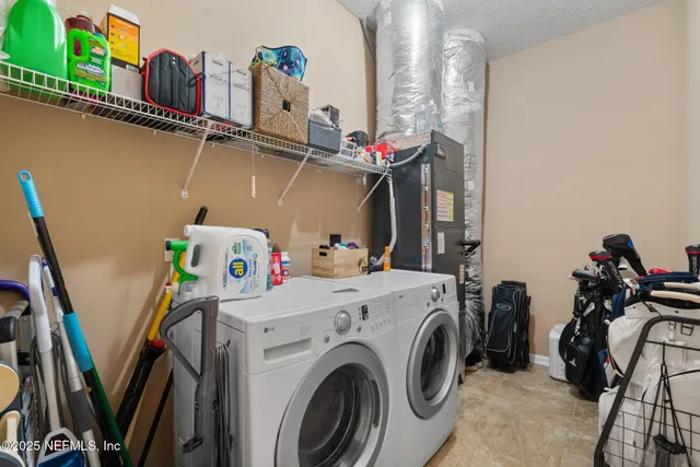 an aerial view of a house with swimming pool and outdoor seating