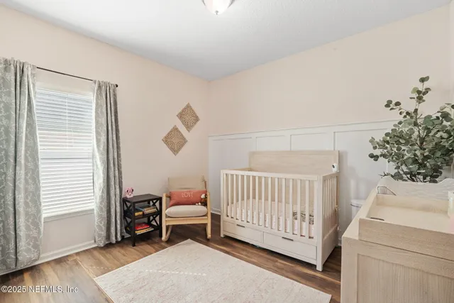 an aerial view of residential houses with outdoor space and trees