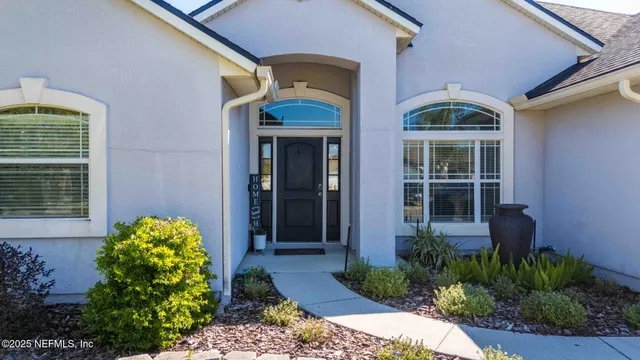 a view of a dining room with furniture a chandelier and wooden floor