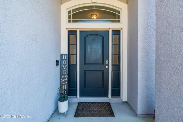 a bedroom with a bed and a chandelier fan