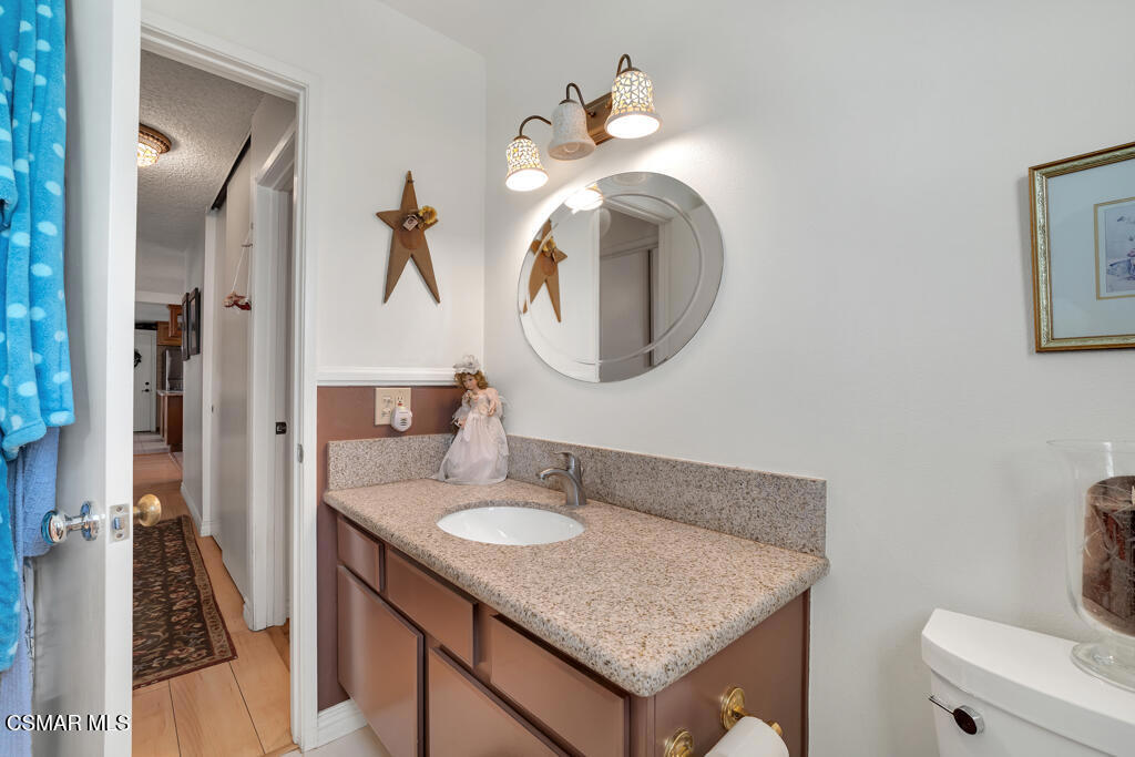 1278 Rambling Road Simi Valley, CA 93065 - Photo 22 of 76 a en suite bathroom with a granite countertop sink and a mirror
