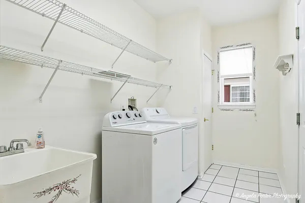 a utility room with a sink dryer and washer