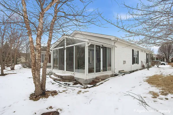 a view of a house with snow on the road