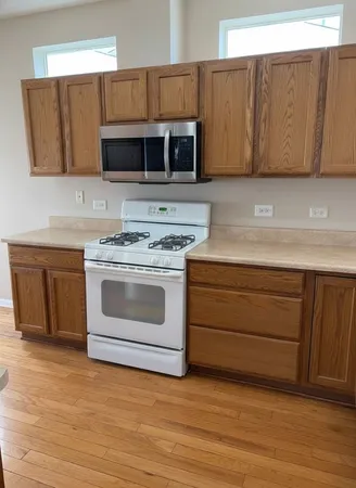 a kitchen with granite countertop white cabinets and stainless steel appliances