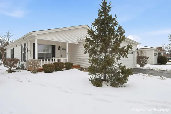 a view of a house with a yard covered in snow