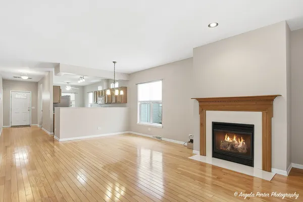 a view of a kitchen empty room and fire place