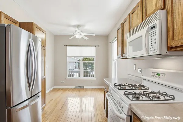 a kitchen with stainless steel appliances granite countertop a stove a refrigerator and a stove