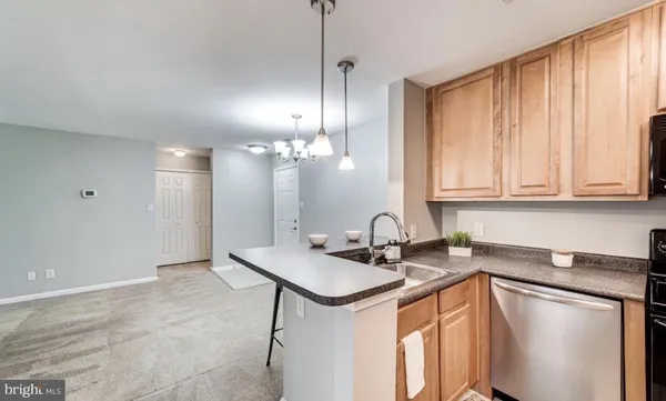 a kitchen that has a sink and a stove in it