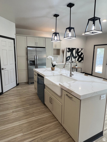 160 200 West Henefer, UT 84033 - Photo 4 of 25 Modern kitchen featuring an expansive center island with a farmhouse sink and light-toned countertops