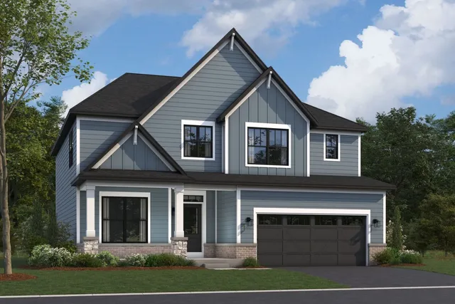 a front view of a house with yard and parking