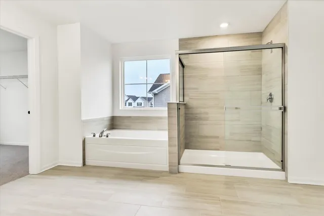a bathroom with a bathtub and a shower