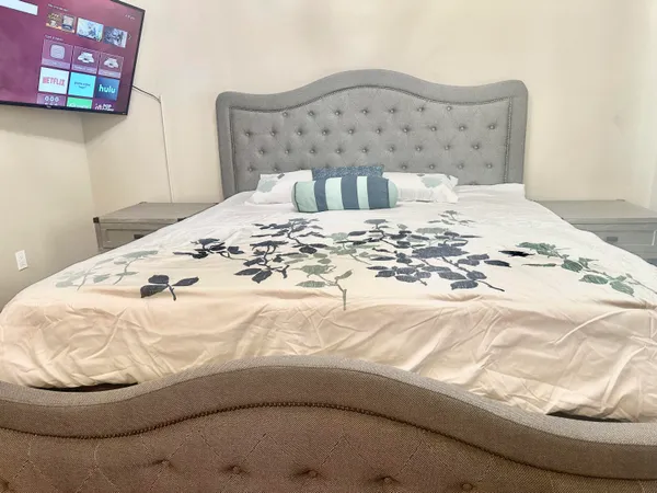 a bedroom with a bed and a chandelier