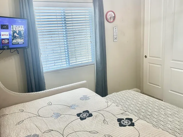 a bedroom with a bed and a chandelier