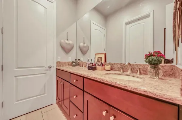 a white toilet sitting next to a white curtain and curtain