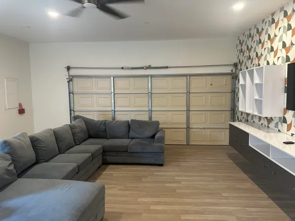 a living room with furniture and a large window