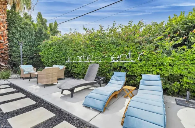 a view of a backyard with sitting area