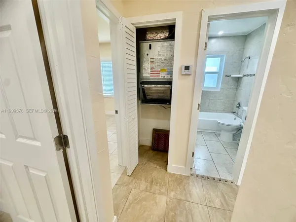 a bathroom with a granite countertop shower and a sink