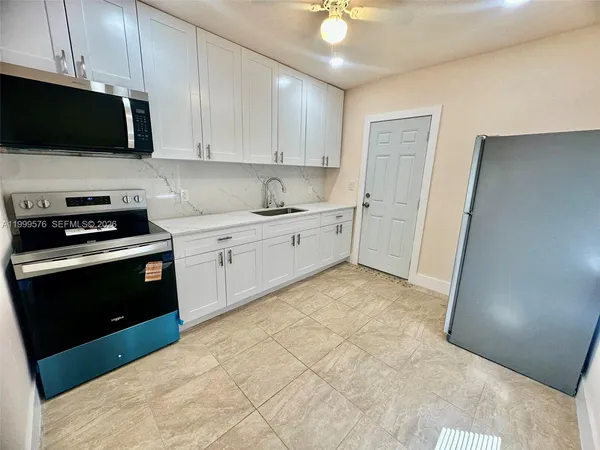a kitchen with a sink and a stove top oven