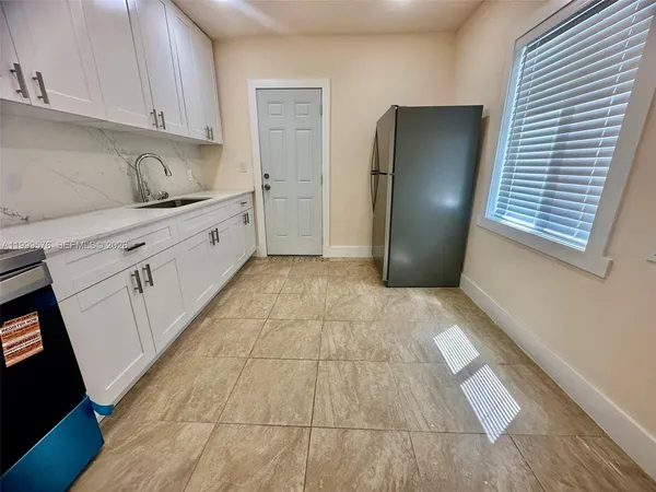 a kitchen with a refrigerator and cabinets