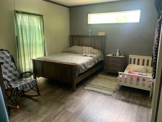 a bedroom with two beds and a chair