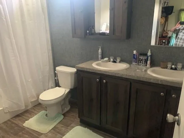 a bathroom with a toilet sink and mirror
