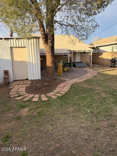 1129 11th Street Douglas, AZ 85607 - Photo 13 of 13 a view of backyard with outdoor seating and a tree