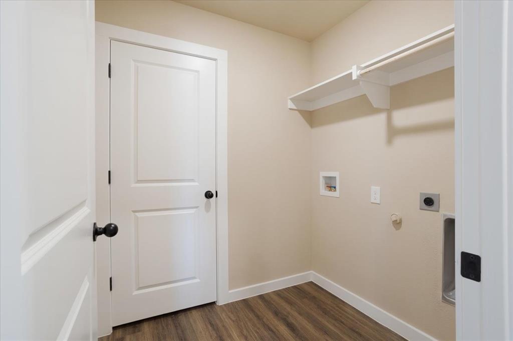 2385 Miller Street Denison, TX 75020 - Photo 12 of 26 a view of a hallway with wooden floor