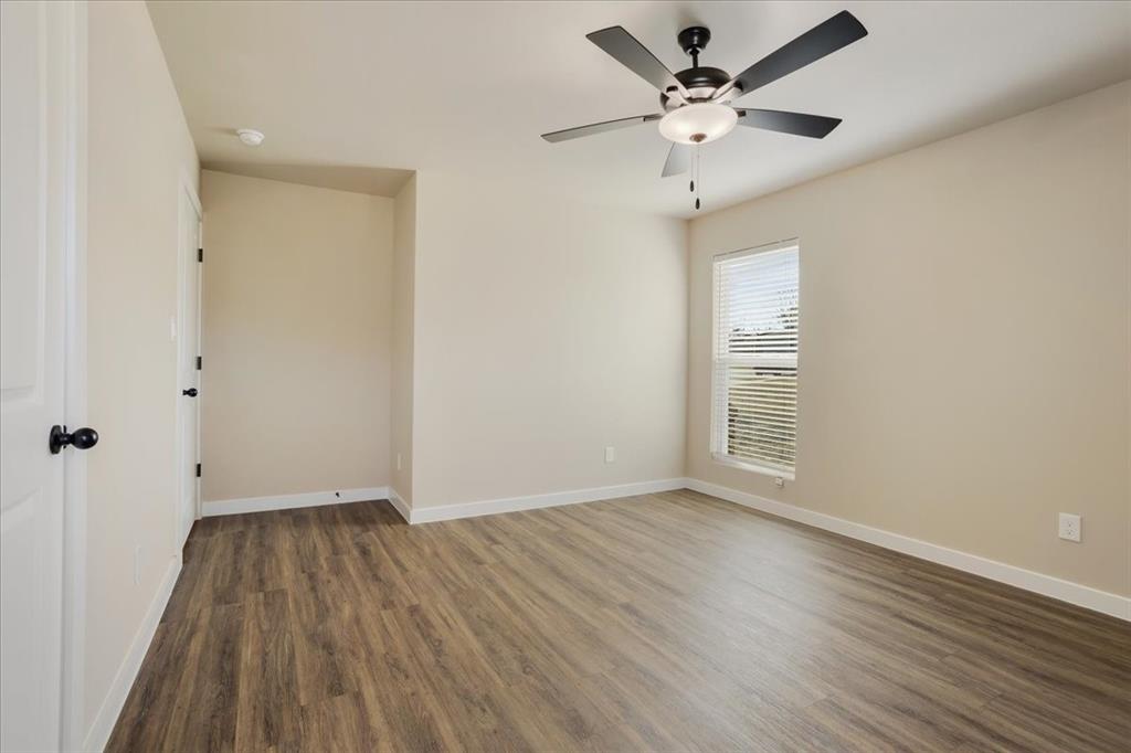 2385 Miller Street Denison, TX 75020 - Photo 15 of 26 wooden floor in an empty room with a window