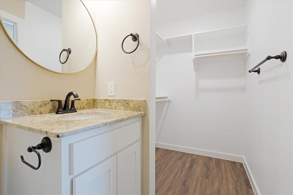 2385 Miller Street Denison, TX 75020 - Photo 17 of 26 a bathroom with a granite countertop sink and a mirror