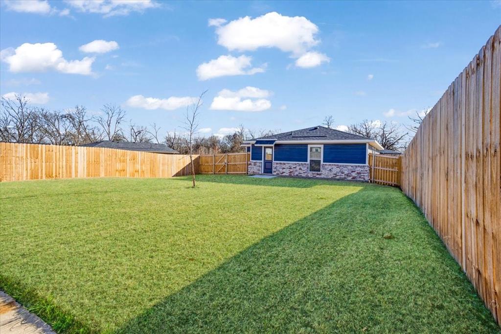 2385 Miller Street Denison, TX 75020 - Photo 25 of 26 a view of a house with a yard and sitting area