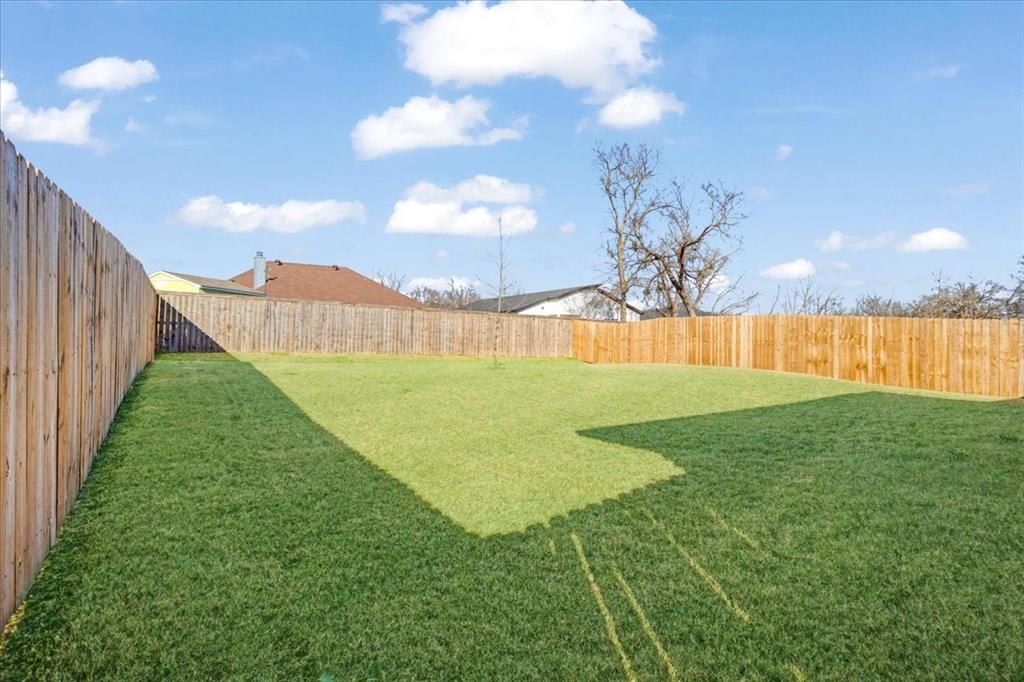 2385 Miller Street Denison, TX 75020 - Photo 26 of 26 a view of a big yard with a trampoline