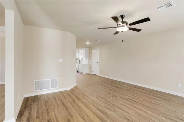 a view of an empty room and wooden floor