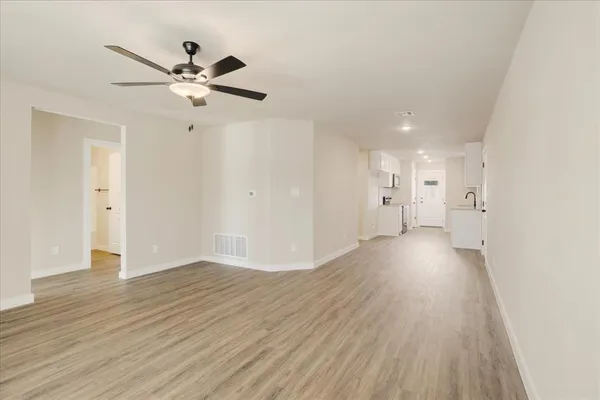 a view of a livingroom with a hardwood floor and a ceiling fan