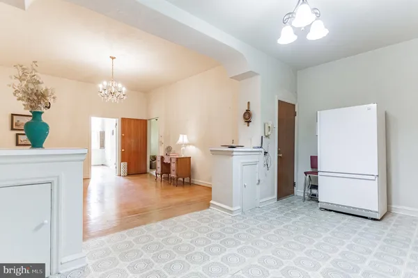 a large kitchen with a table and chairs