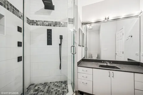 a bathroom with a granite countertop shower and a sink
