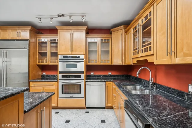 a kitchen with stainless steel appliances granite countertop a stove and a sink