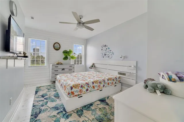 a bedroom with two beds and painting on the wall