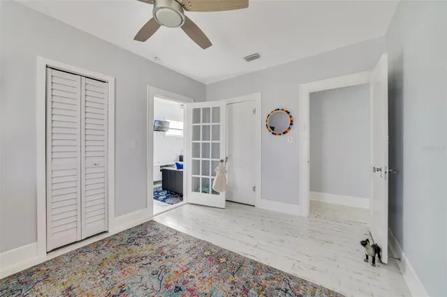a view of a livingroom with wooden floor and a ceiling fan