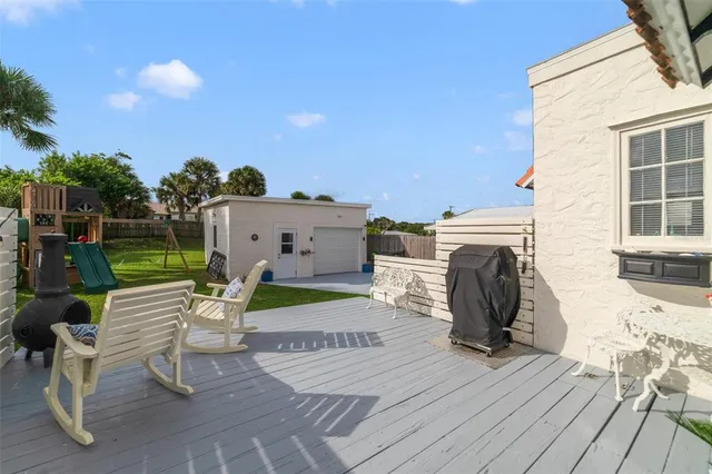 a view of a patio with a table and chairs