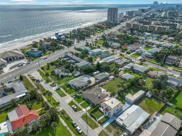 an aerial view of residential houses with outdoor space