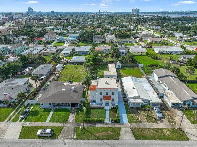 an aerial view of residential houses with outdoor space and street view