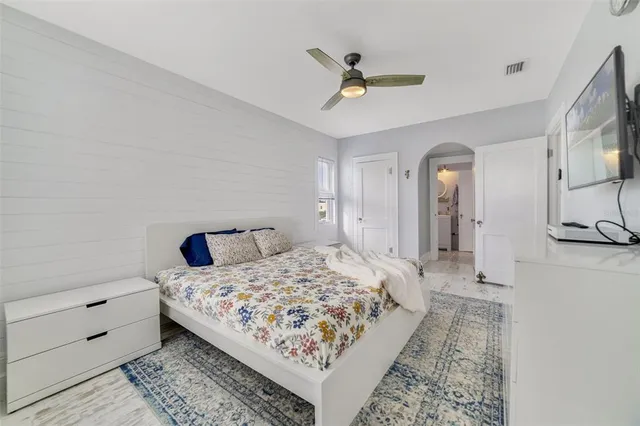 a bedroom with a bed and a mirror