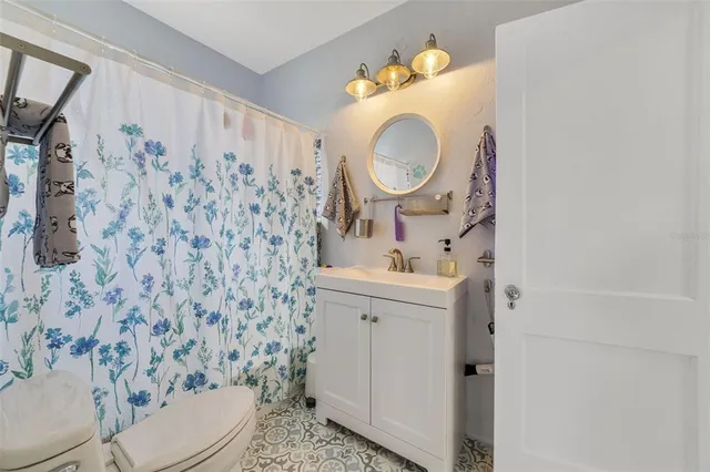 a bathroom with a sink a toilet and a mirror