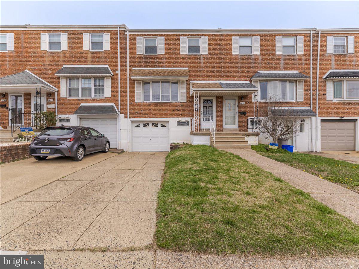 3249 Byberry Road Philadelphia, PA 19154 - Photo 1 of 28 a front view of a residential apartment building with a yard