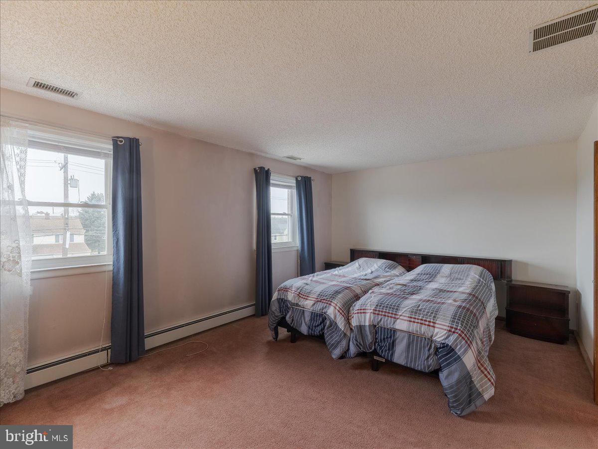 3249 Byberry Road Philadelphia, PA 19154 - Photo 14 of 28 a bed sitting in a bedroom next to a window