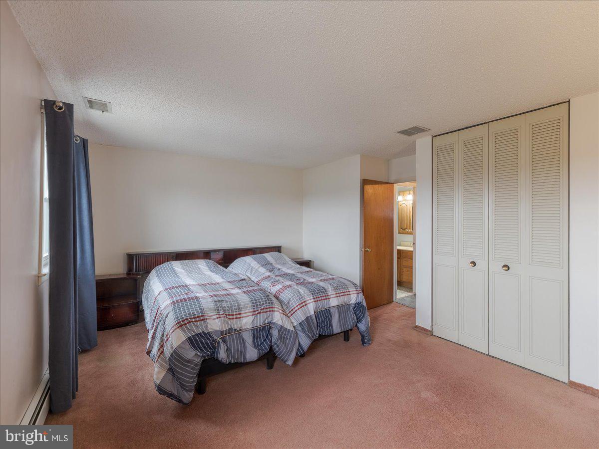 3249 Byberry Road Philadelphia, PA 19154 - Photo 15 of 28 a bed sitting in a bedroom next to a bathroom