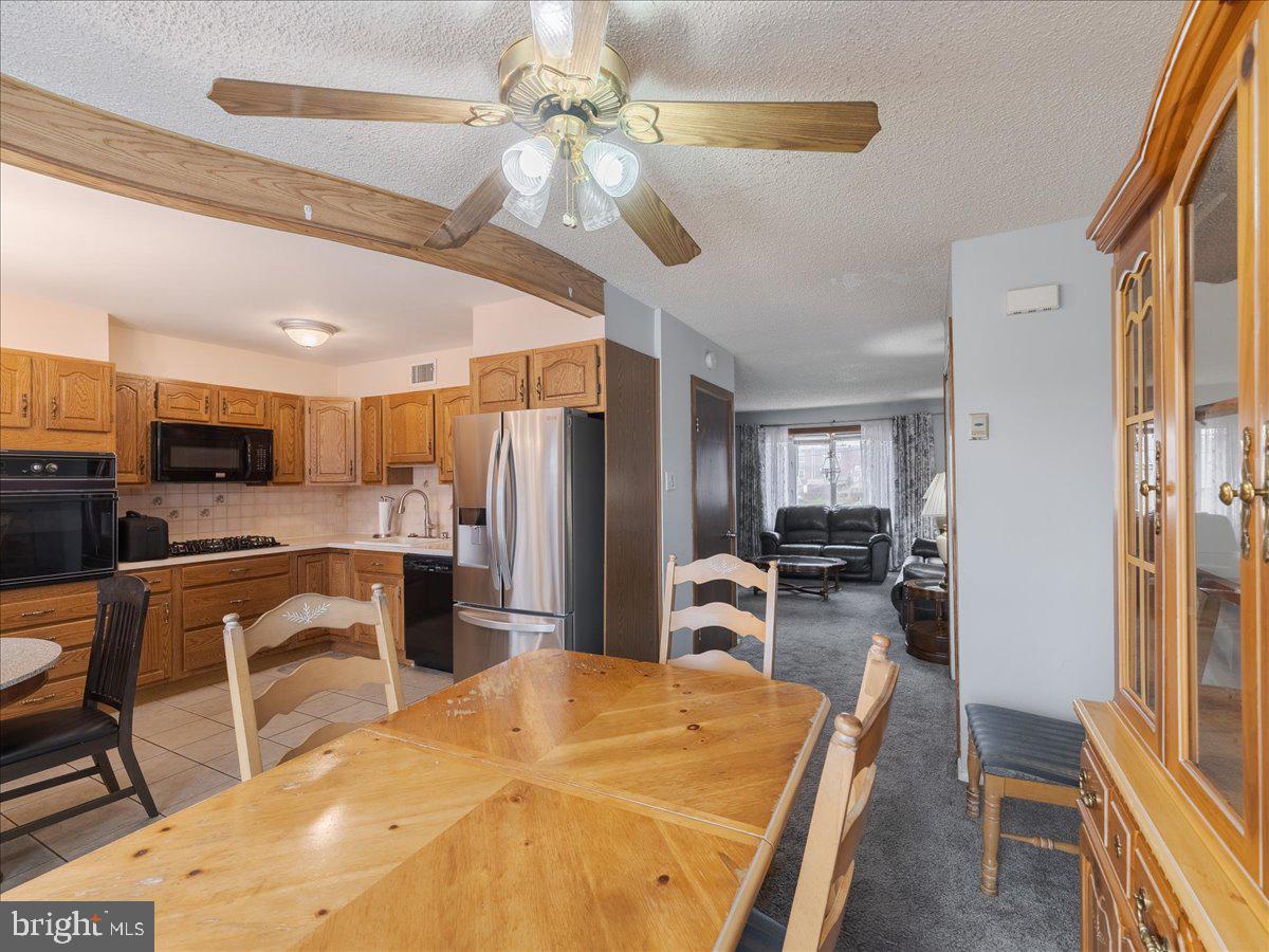 3249 Byberry Road Philadelphia, PA 19154 - Photo 8 of 28 a large kitchen with a table chairs refrigerator and cabinets