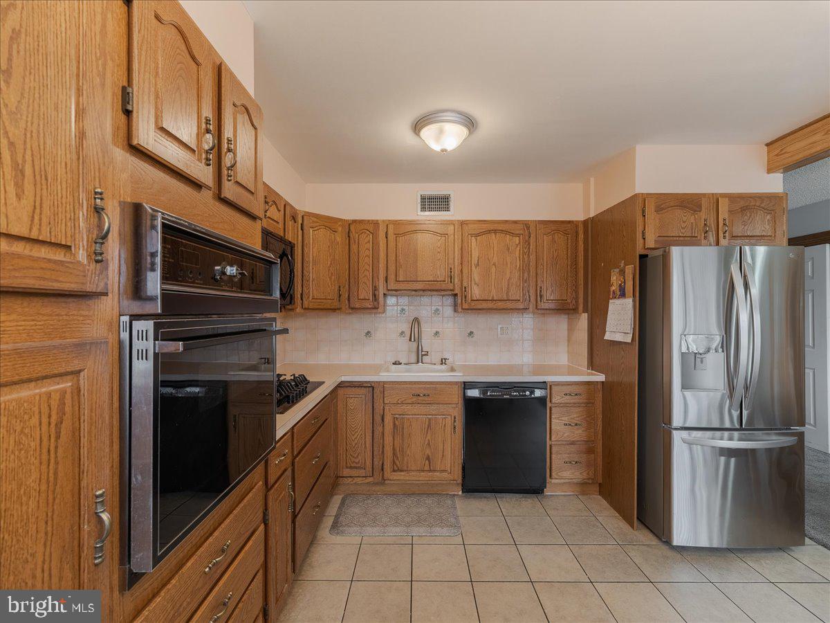 3249 Byberry Road Philadelphia, PA 19154 - Photo 10 of 28 a kitchen with stainless steel appliances granite countertop a refrigerator and a stove top oven