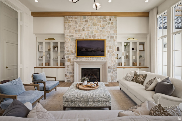 478 South Maple Lakes Drive Mapleton, UT 84664 - Photo 14 of 51 Stone-clad fireplace with a classic mantelpiece, flanked by built-in cabinetry with glass-front uppers and recessed lighting