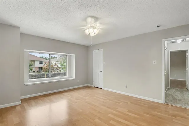 an empty room with windows and closet